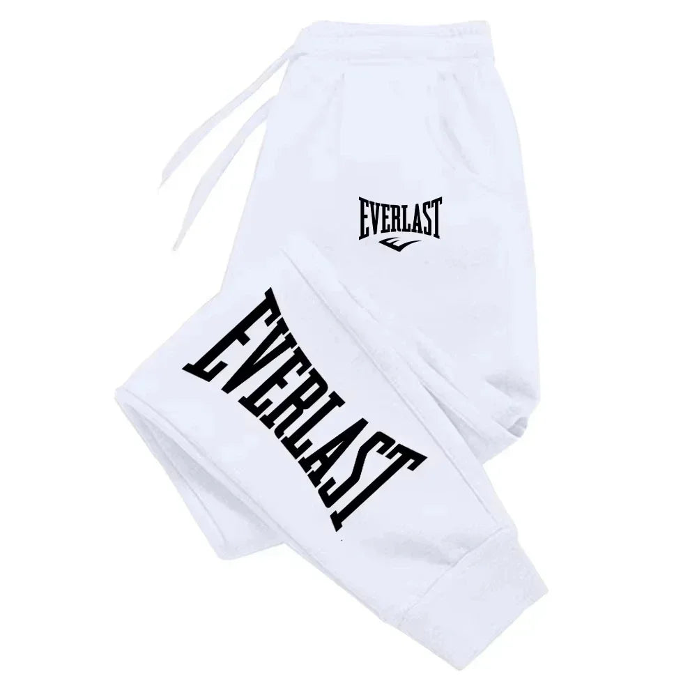 White sweatpants with "Everlast" logo in black on the leg and waist, featuring a drawstring.