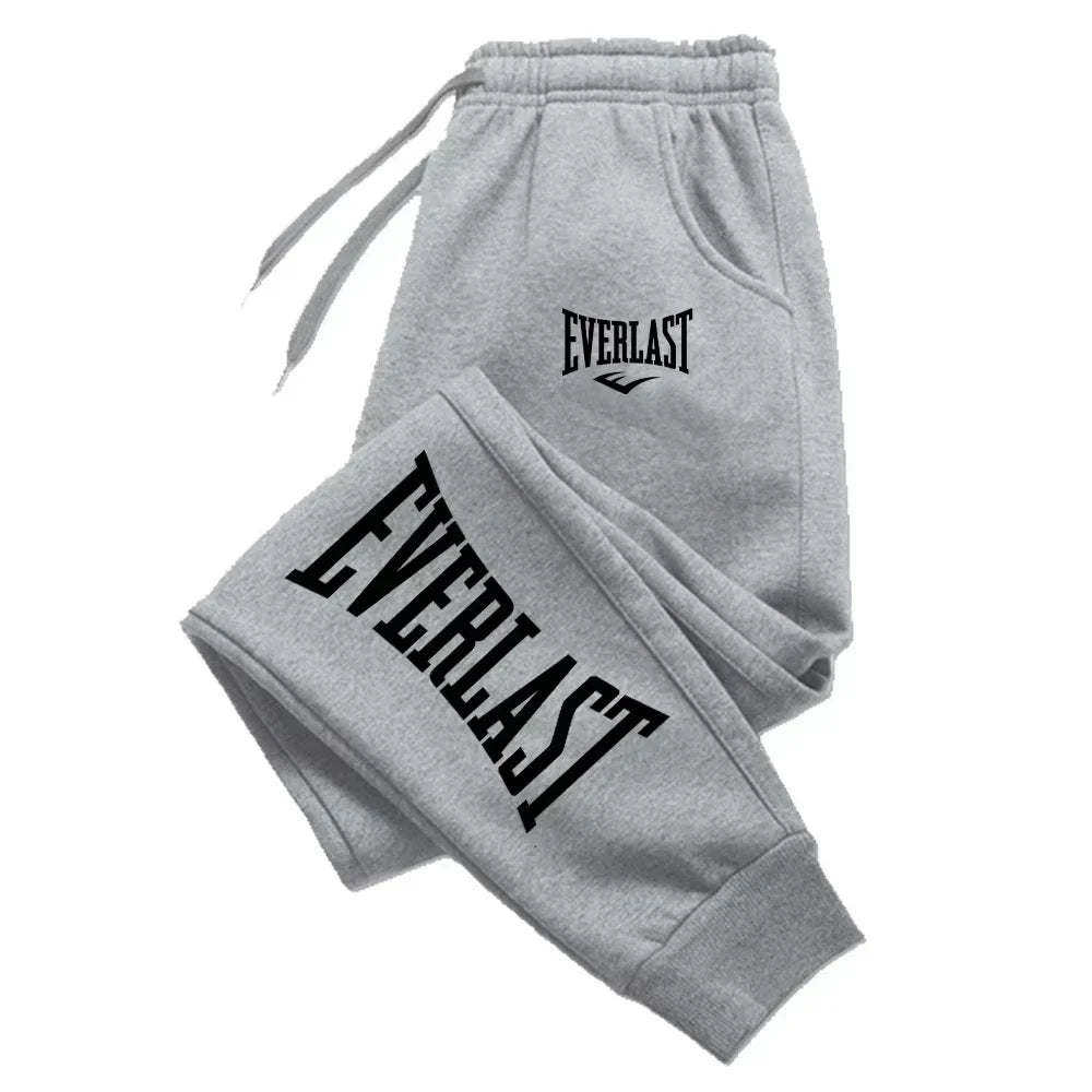 Gray sweatpants with "Everlast" logo in black on the thigh and waist, featuring an elastic waistband.